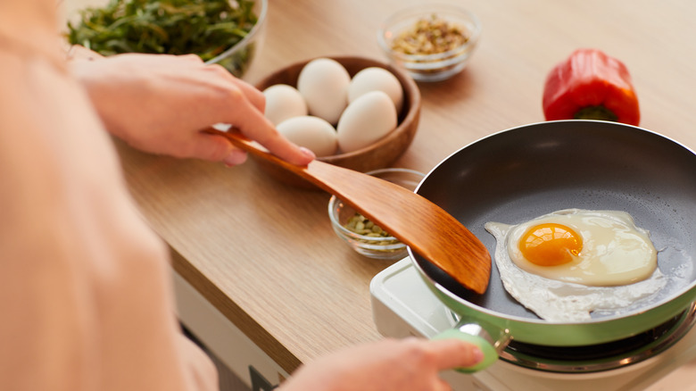 woman cooking an egg