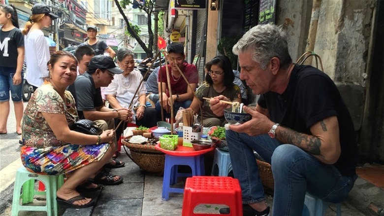 Anthony Bourdain eating from bowl in Vietnam