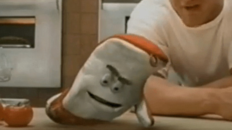 Arby's Oven Mitt doing push-ups on the counter