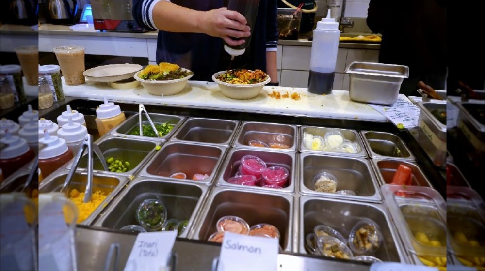 chef assembling a poke bowl