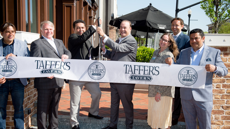 Jon Taffer cutting a ribbon at Taffer's Tavern