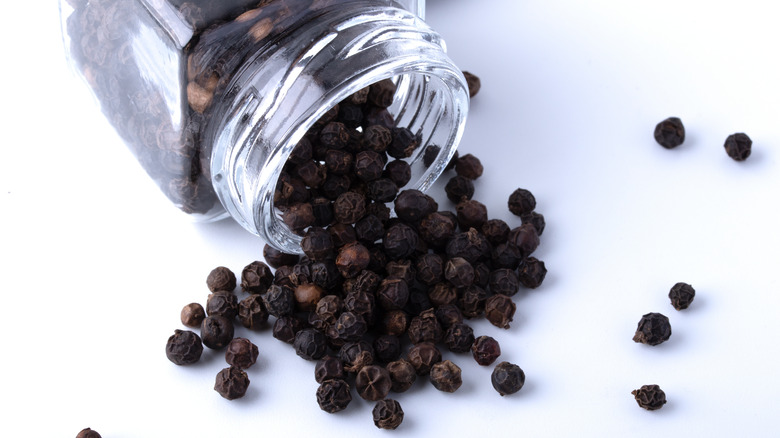 A glass jar of black pepper