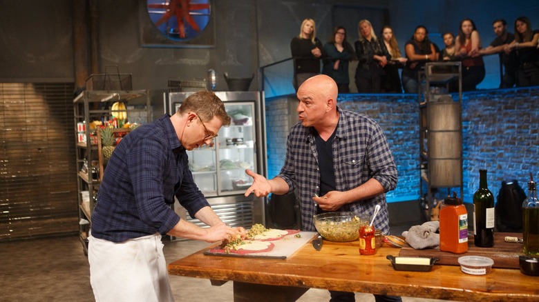 Bobby Flay cooking during Beat Bobby Flay