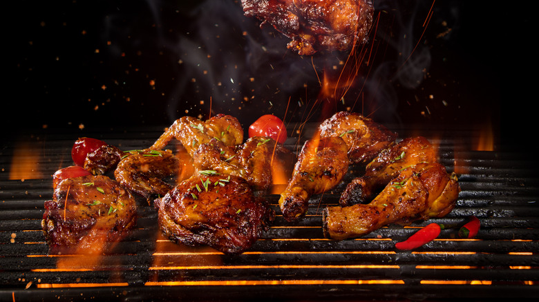 Chicken on a grill on a black background