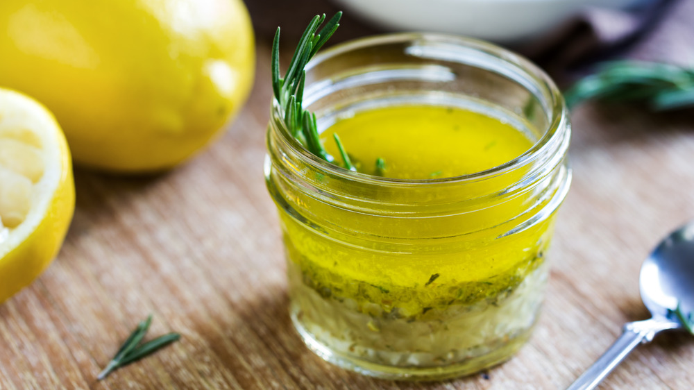 Vinaigrette in a glass jar with rosemary and lemon