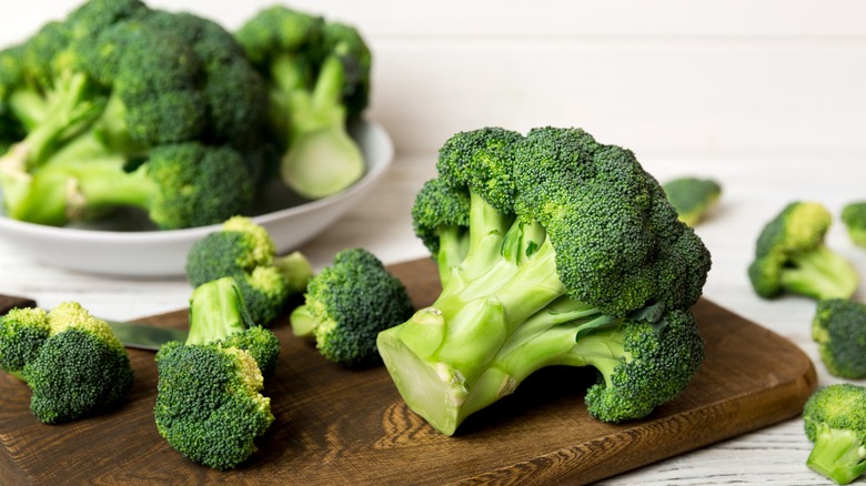 cut up broccoli on a cutting board