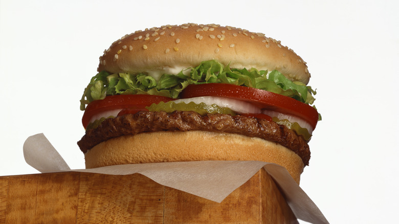 Hamburger with toppings on a wooden counter