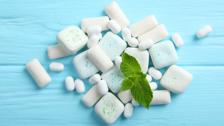 assortment of gum and breath mints on table