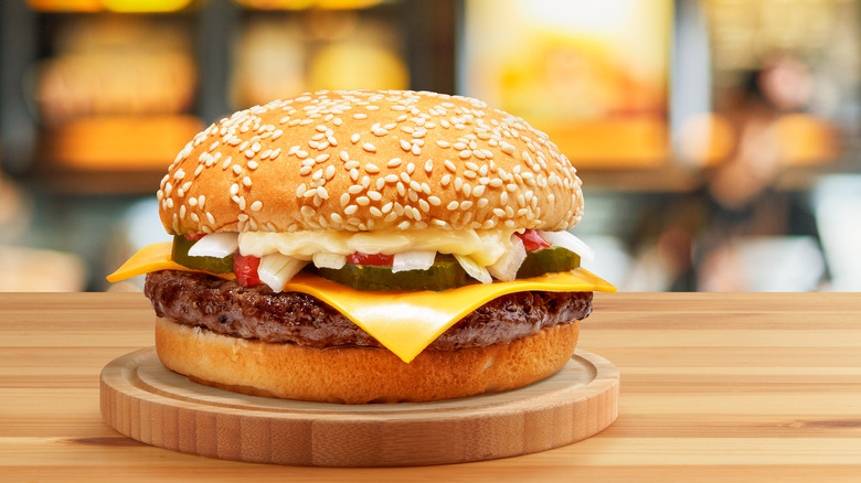 Cheeseburger on a butcher block platform