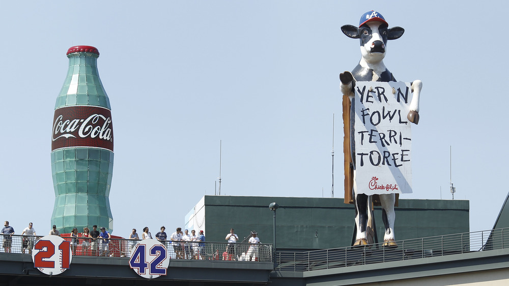 Giant Chick-fil-A cow wearing baseball cap