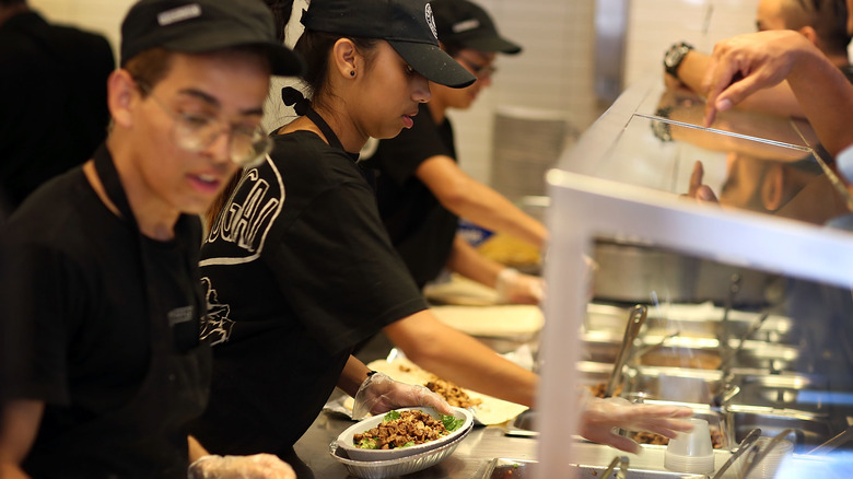 Chipotle employees serving food to customers