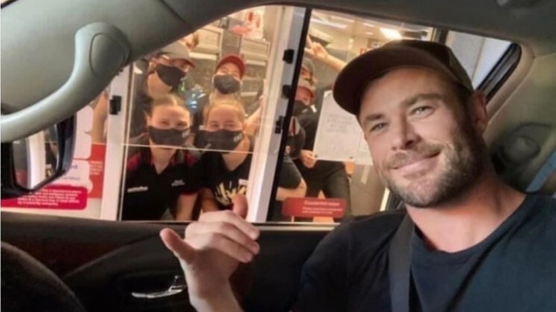 Chris Hemsworth smiling with KFC employees