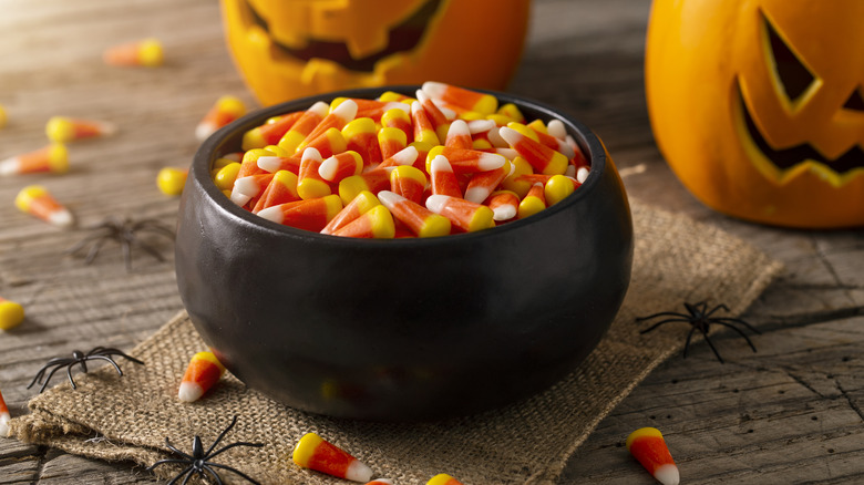 Candy corn displayed with Halloween decorations