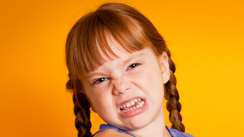 Young redheaded girl disgusted