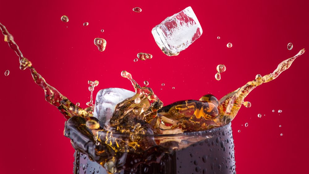 ice splashing into a coca-cola