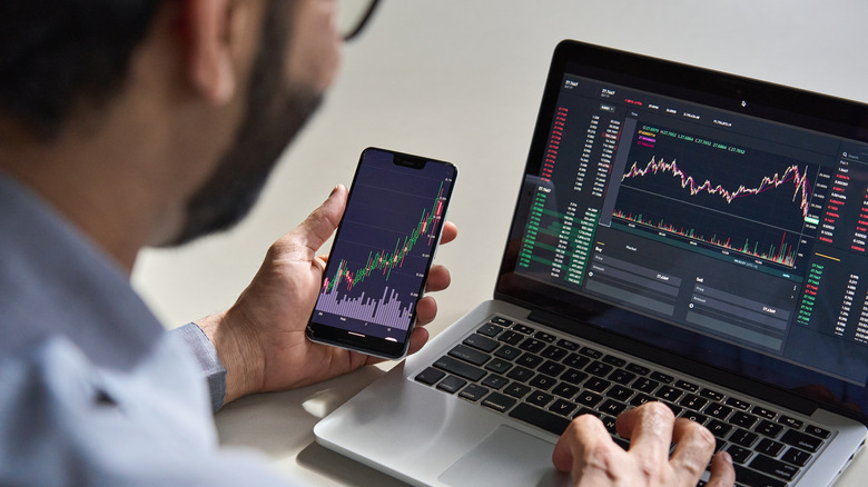 person checking stocks on devices