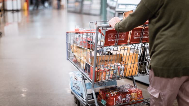 A Costco shopper rolls a shopping cart