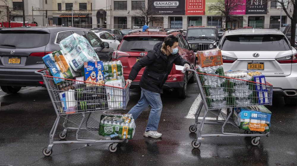 Costco shopper with paper towels and water