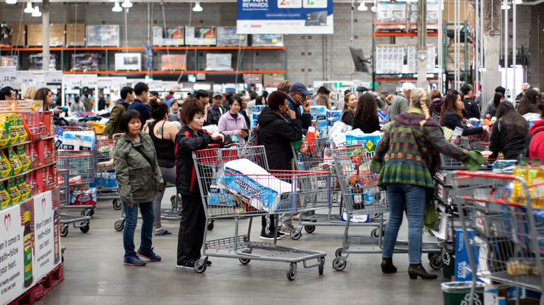 Shoppers waiting in lines at a busy Costco