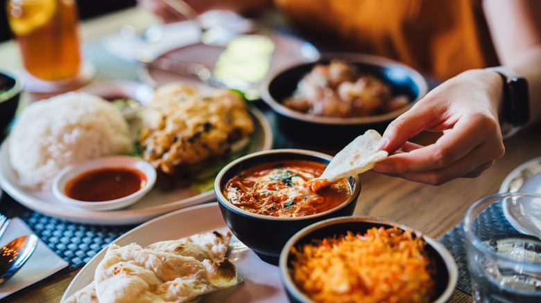 person eating dip in restaurant