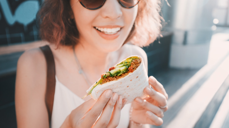 Girl holds taco/wrap