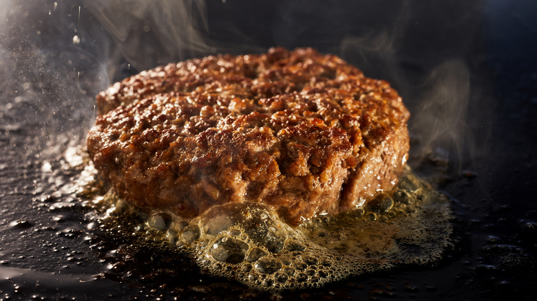 Juicy burger on griddle