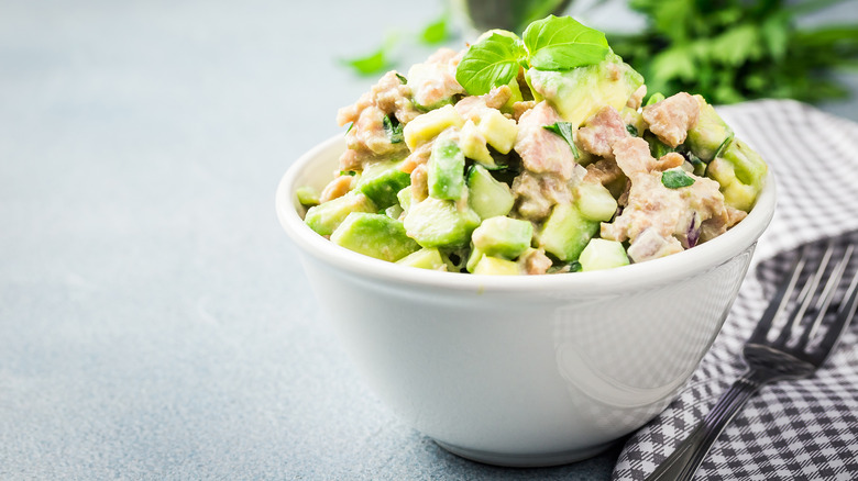 Tuna salad with avocado chunks in a white bowl