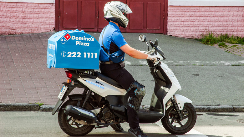 Domino's Pizza delivery person on a motorcyle