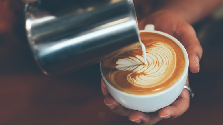 Pouring milk into a coffee