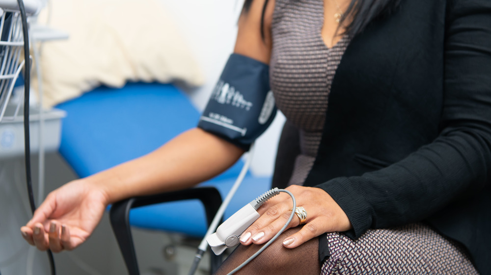 Woman getting pulse and blood pressure checked