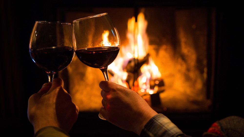 Couple holding wine glass fire