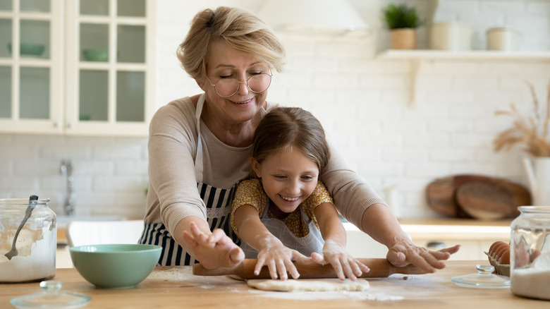 Grandmother and granddaughter cooking together in the kitchen