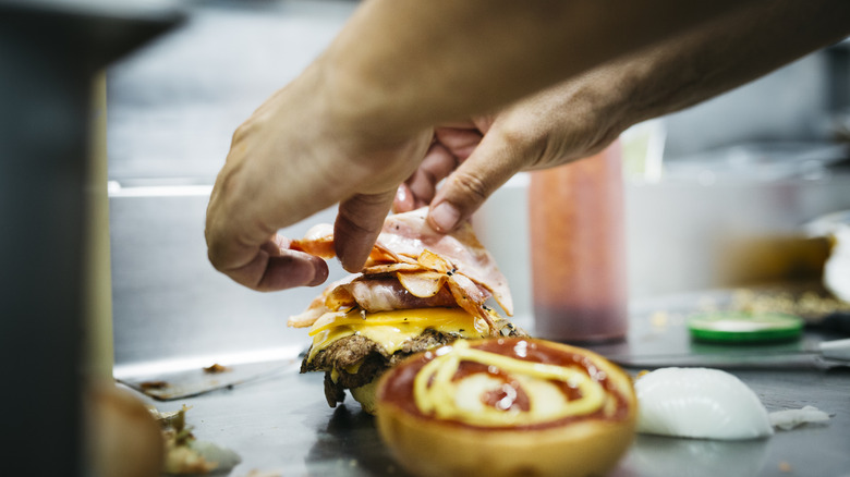 Chef preparing fast food burger