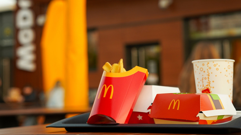 Fast food tray with fries, burger, and soda