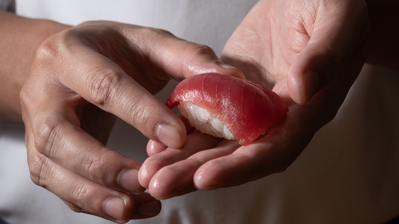 chef holding tuna nigiri