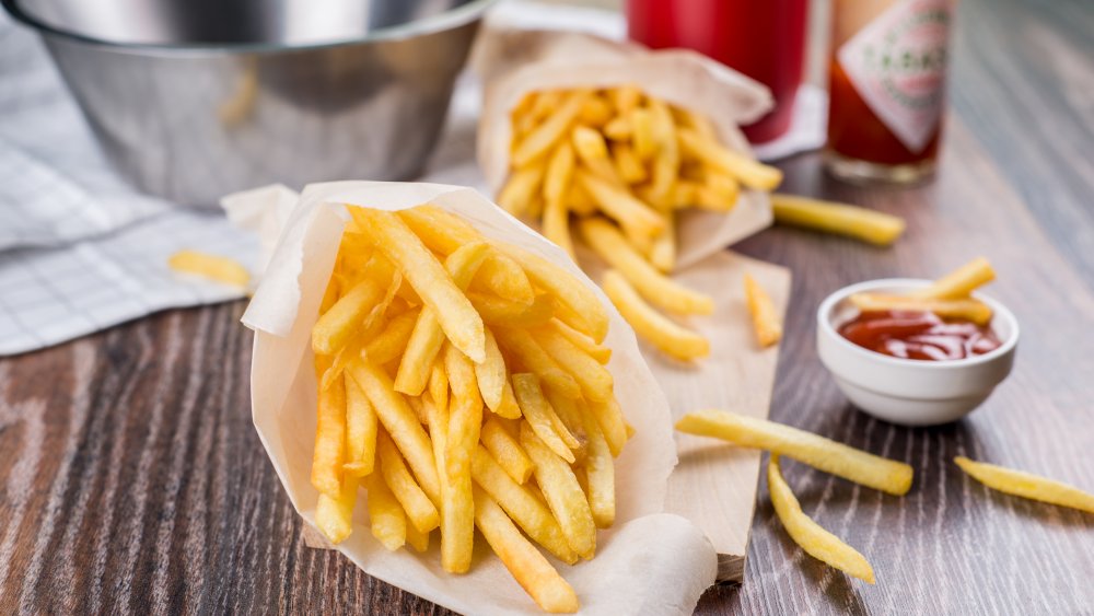 Fries with ketchup and hot sauce