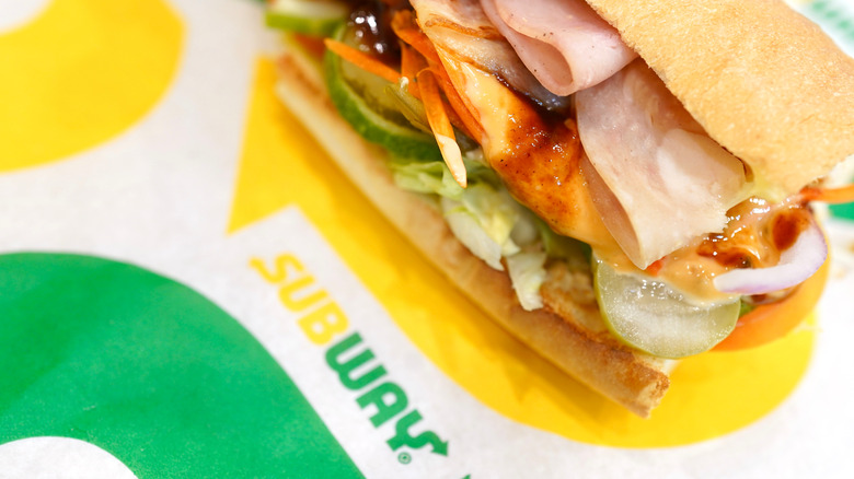 Subway sandwich on green and yellow paper