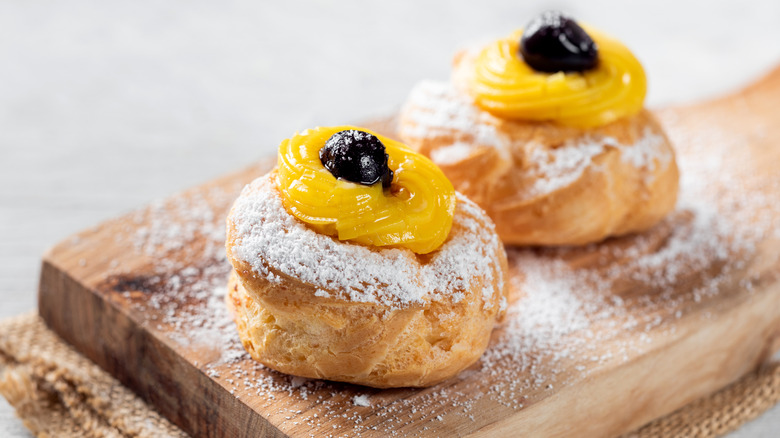 Zeppole di San Giuseppe on wooden board