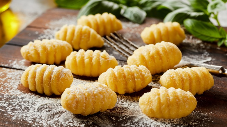 Uncooked gnocchi on cutting board