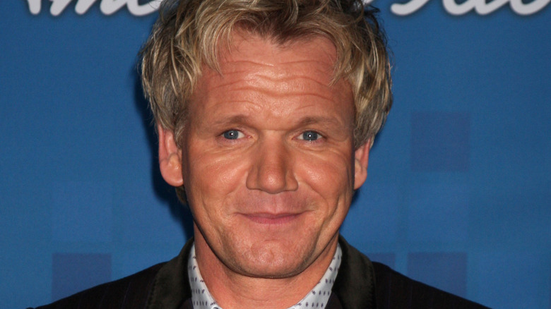 Gordon Ramsay smiles with long hair