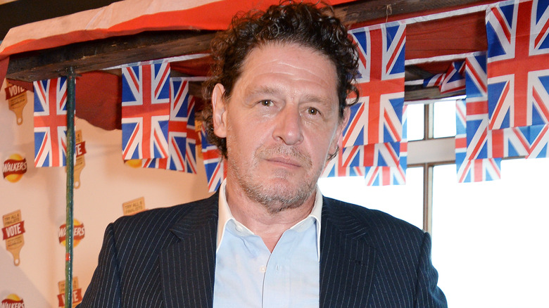 Marco Pierre White wears a pinstriped suit