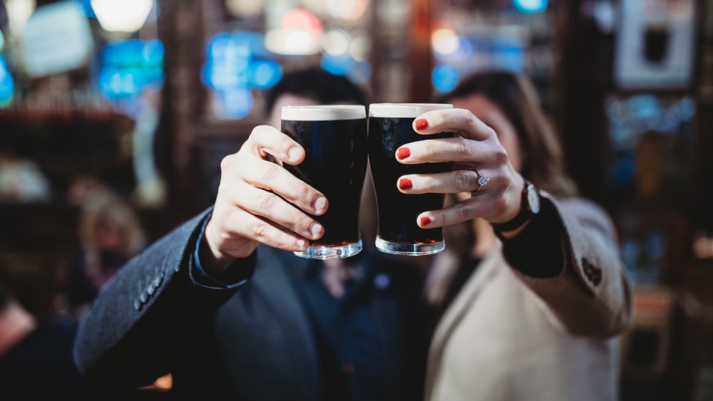 Two people cheers with Guinness