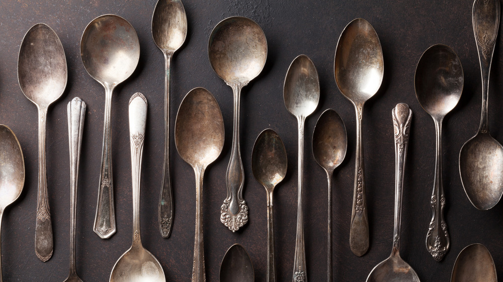 antique spoons on gray background