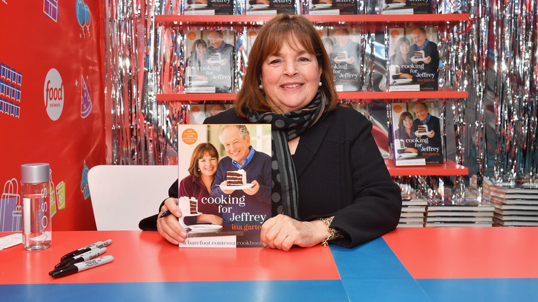 Ina Garten posing with her cookbook