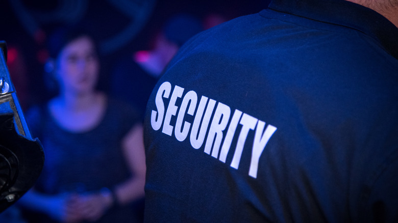 Guard wearing shirt that says security