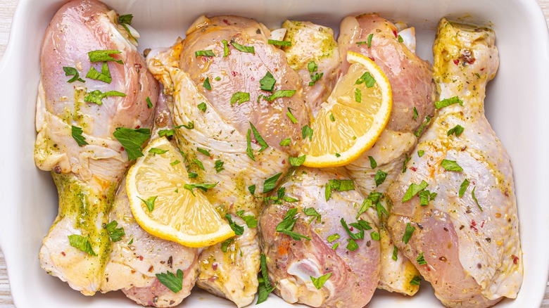 Raw chicken legs with lemon