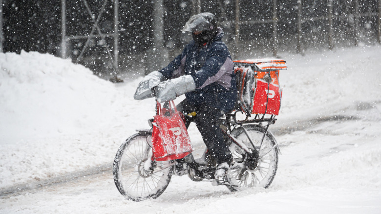 DoorDash courier delivering in the snow