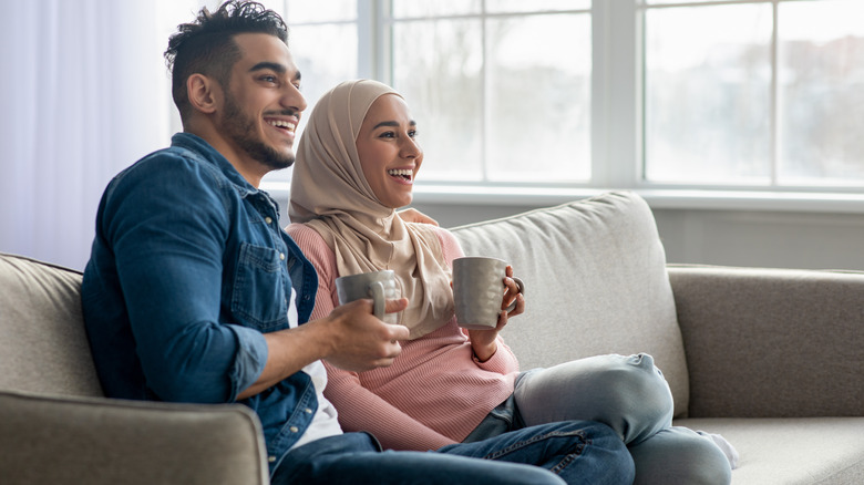 Couple drinking tea watching TV