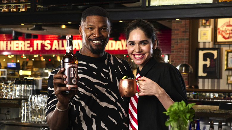 Jamie Foxx behind TGI Fridays bar with BSB bourbon