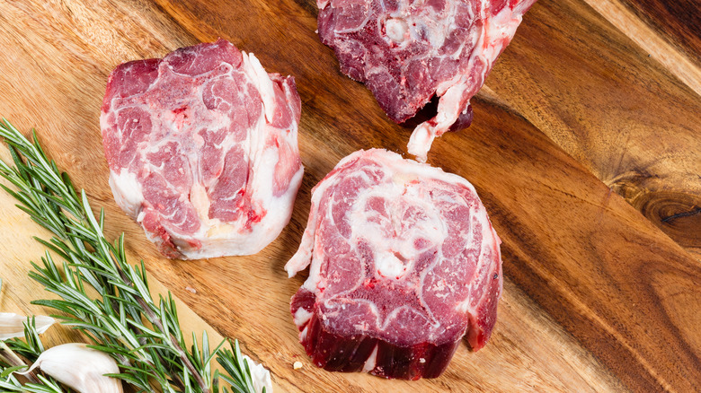 raw lamb neck on cutting board